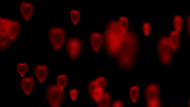 The camera rotates around an array of hearts. Focusing and defocusing on three-dimensional images of hearts.