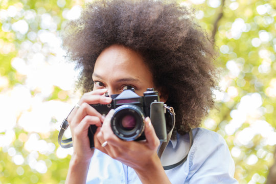 Charming Black Woman With Old Retro Camera In Nature