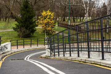 fenced Bike Path on the bridge over the river in the city in the