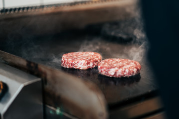 Preparing delicious meat burgers. Close-up.