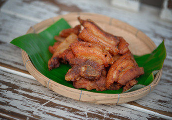  fried pork, style thai food on wooden background.