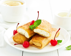 Russian crepes stuffed with curd and cherry.