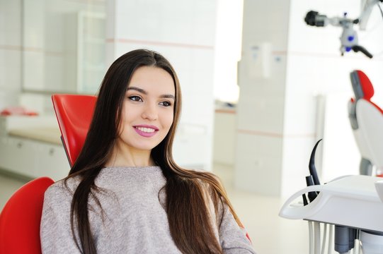A pretty girl patient in a dental chair awaits a dentist. Tooth Health