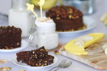 Pistachio cake served with cream milk and banana