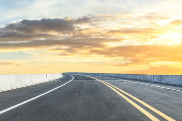 Clean asphalt highway and beautiful sky clouds at sunset