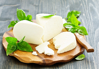 cheese brynza  and garlic on a cutting board.