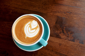 Hot latte on a wooden table