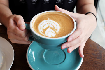Hot latte on a wooden table