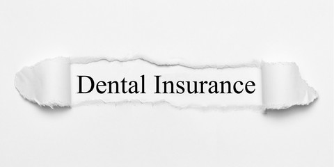 Dental Insurance on white torn paper