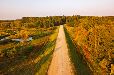 Rural dirt road view from above. Aerial view on countryside road with forest