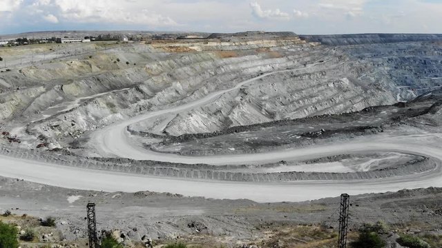 Aerial view of the large industrial quarry for the extraction of iron ore. 4k video