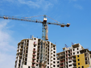 Fototapeta na wymiar Construction site background. Crane and building under construction.