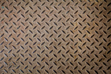 Steel texture from Manhole cover. Metallic background and wallpaper. Detail of Manhole cover pattern.Metal diamond plate pattern and background seamless.