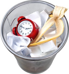 Alarm Clock, Banana Peel And Paper In Trash Bin - Isolated