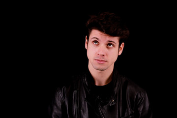 Fototapeta premium Thinking man standing in front of black background
