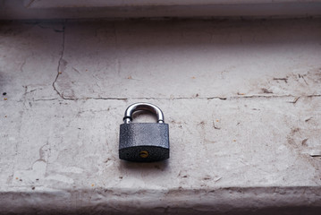 black door lock on a wooden window sill