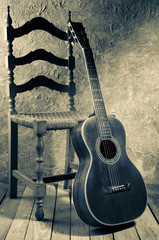 Obraz premium vintage gitara bluesowa ze starym krzesłem