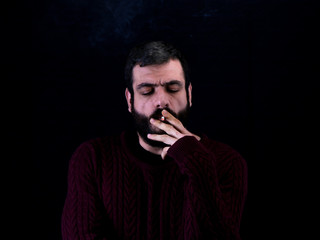 portrait of smoker man in front of black background