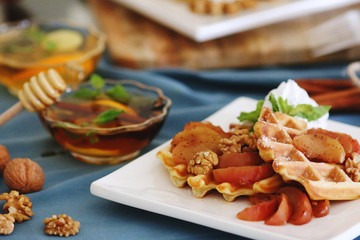 waffles sered with walnuts, honey and baked aples
