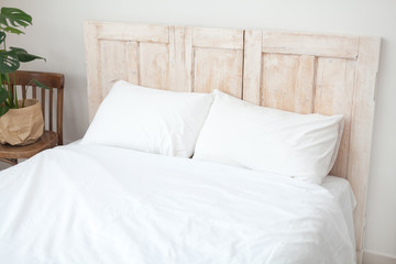Loft design. Scandinavian interior room. White bed linen.