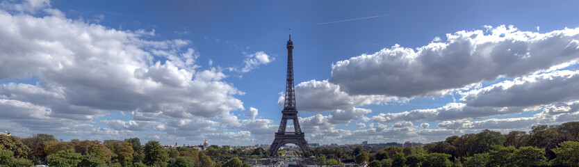 Panoramic view of Eiffel tower and surrounding with cloudy sky. Taken from Trocadero in September - Paris, France.