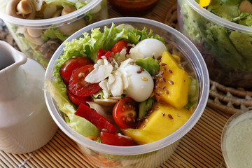 Fresh vegetable salad in an open plastic bowl packing