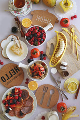 Pancakes served with many fresh fruits and berries
