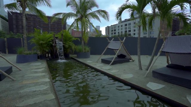 Jungle river and waterfall in New York city tracking shot in slow motion.