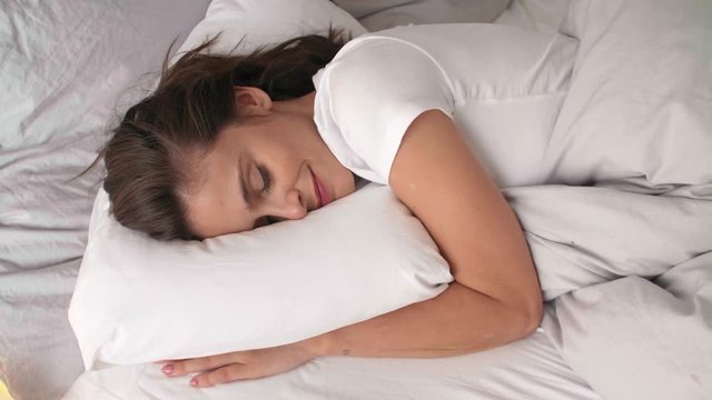 Woman sleeping in comfortable bed