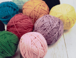 corlorful ball of yarn and white wood background 
