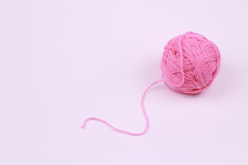 Pinkball of yarn on white background