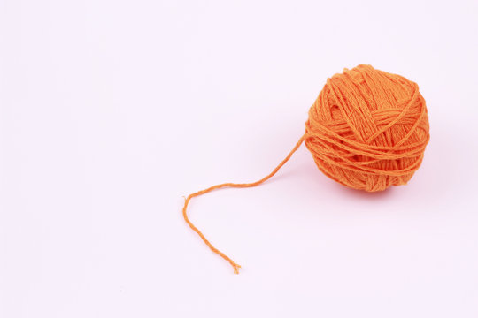 Orange Ball Of Yarn On White Background