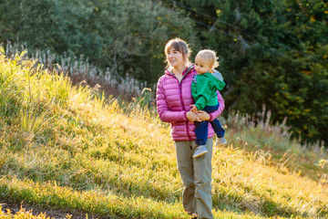 Family, childhood, fatherhood, leisure and people concept - happy father, mother and little toddler...
