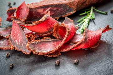 Armenian basturma. Beef cured and spice. Organic products on a wooden table