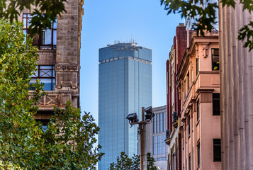 A tall glass covered office building in Melbourne Australia with communications and weather...