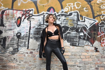 young woman by the old factory wall