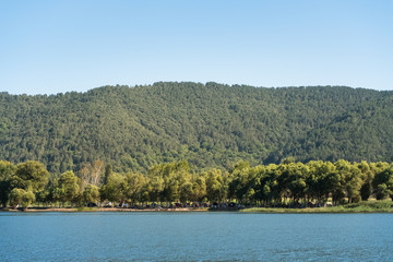 Fototapeta na wymiar Hills and Trees by the Lake Golcuk Odemis Turkey