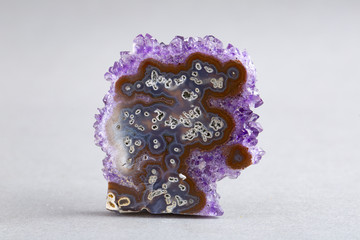 Natural Druse of amethyst on a white background stone