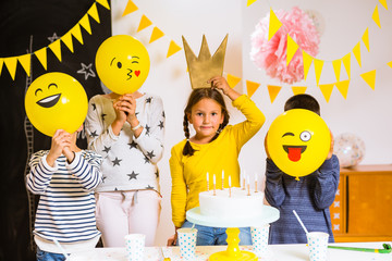 Happy kids holding balloons smiley on birthday party