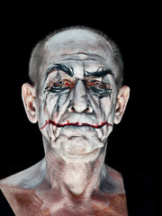 Bloody Halloween theme: The crazy maniak face on dark studio background