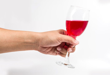 Red wine glass in hand on white background