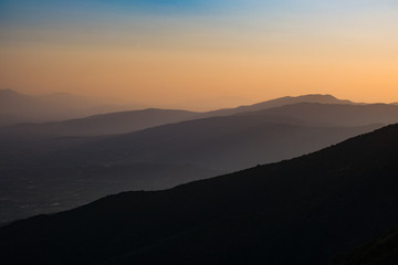 Silhouettes of Mountains and Hills at Dusk