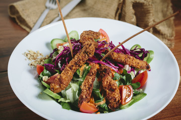 Delicious salad with chicken, nuts, egg and vegetables.