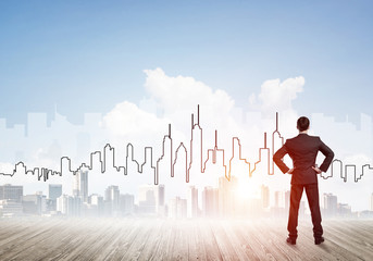 Motivation and inspiration concept with modern cityscape and businessman observing it