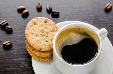 Cup of coffee with crackers