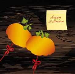Halloween. Pumpkins on a sticks with a bows. Vector on wooden back. Greeting card / invitation to a party. Empty space for text or advertising. Yellow sheet of paper for notes. Sticker.