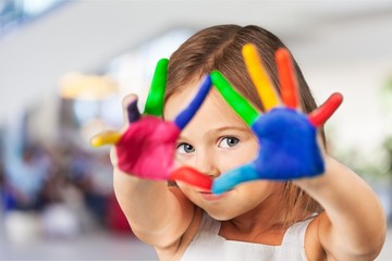 Cute little girl with colorful painted hands