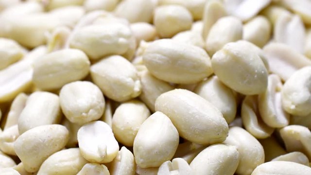 Peeled dry peanuts on a turntable in 4K resolution