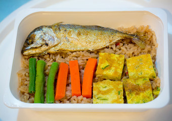 Lunch box famous local thai spicy food, fried rice with shrimp sauce, boiled vegetables and fried mackerel