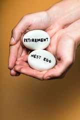 Cupped Hands Holding Two Eggs With the Inscription "Retirement